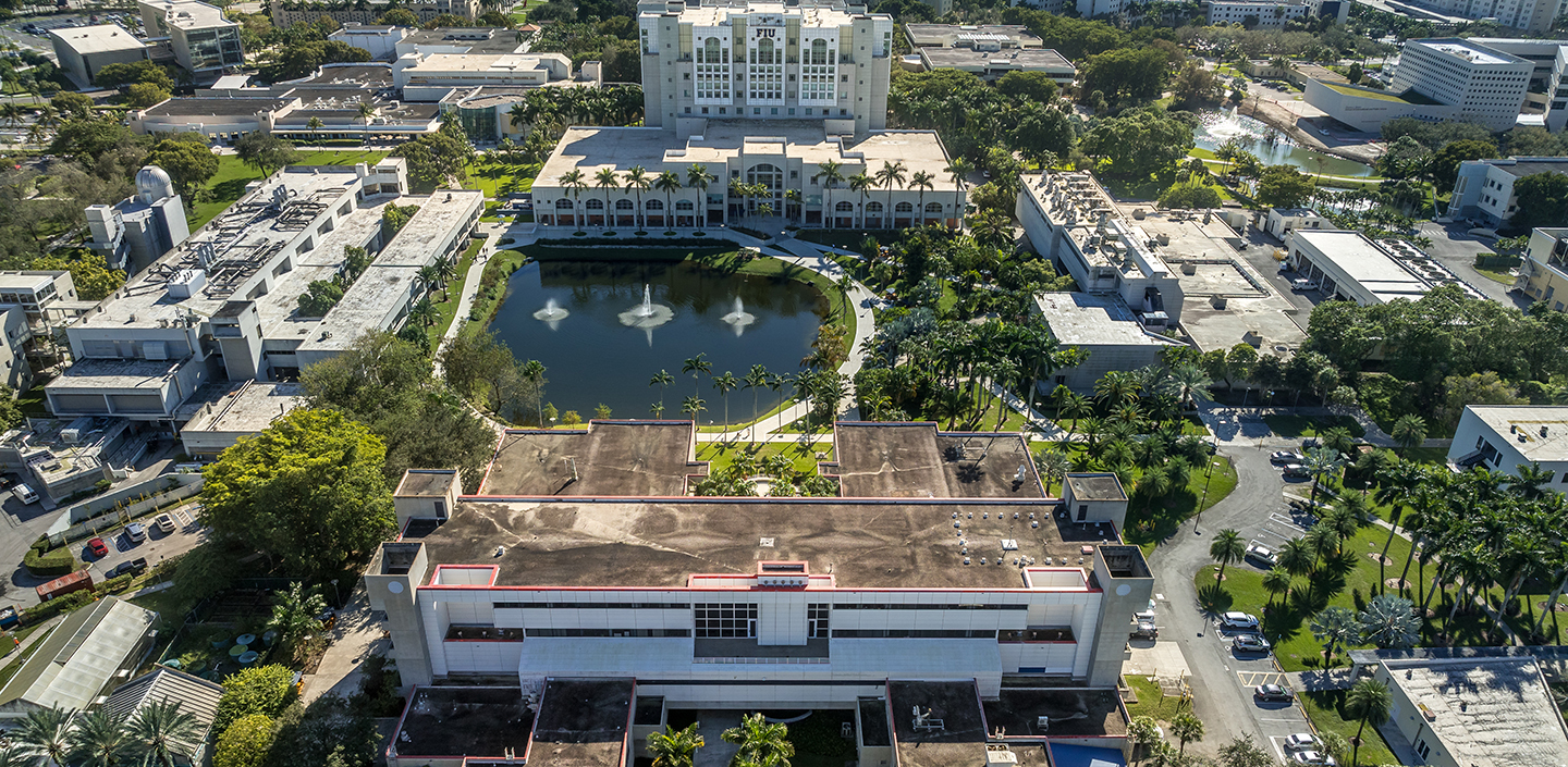 Florida Sea Grant Launches 50th Anniversary Celebration with Commemorative Seminar Series Aerial view of the Florida International University campus featuring a central pond with water fountains, surrounded by academic buildings, palm trees, walkways, and parking lots
