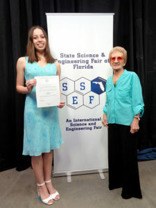 Mary Reed holding an award