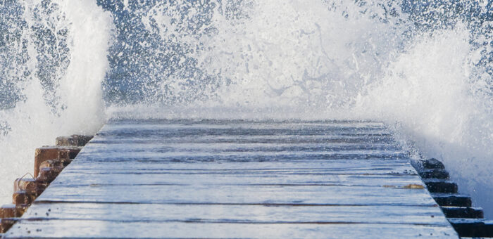 wave splashing against a dock