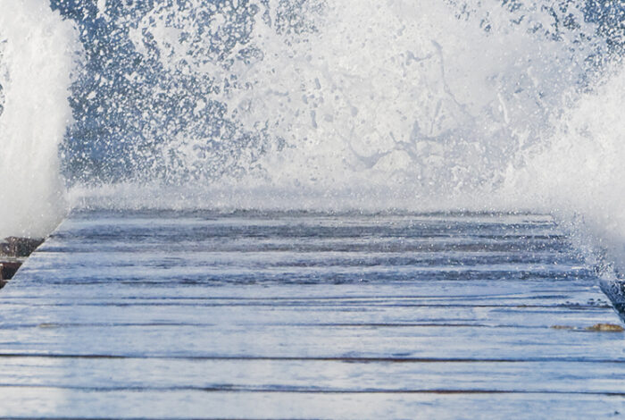 wave splashing against a dock