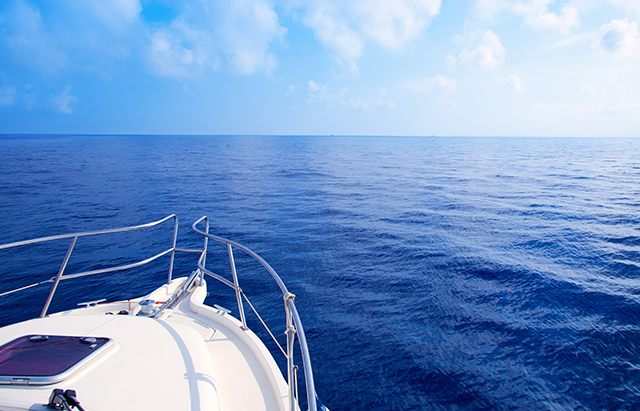 Boat bow sailing in blue Mediterranean sea in summer vacation