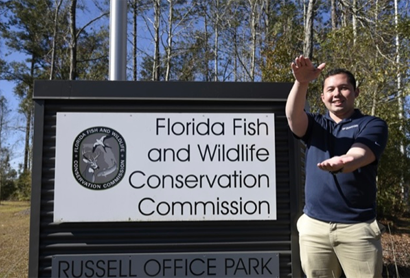 student intern posing next to FWC office sign