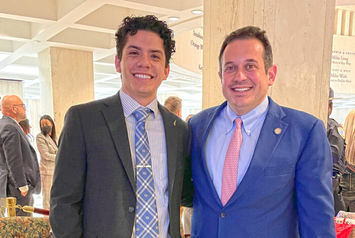 student intern poses and smiles with florida state representative