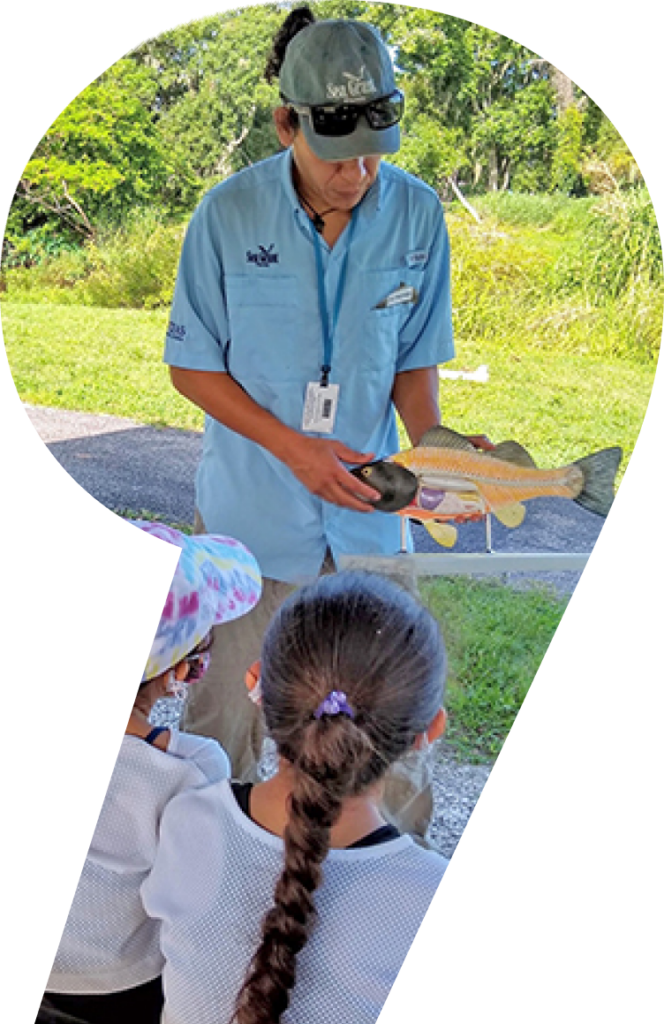 educator pointing to fish model to teach students about fish biology