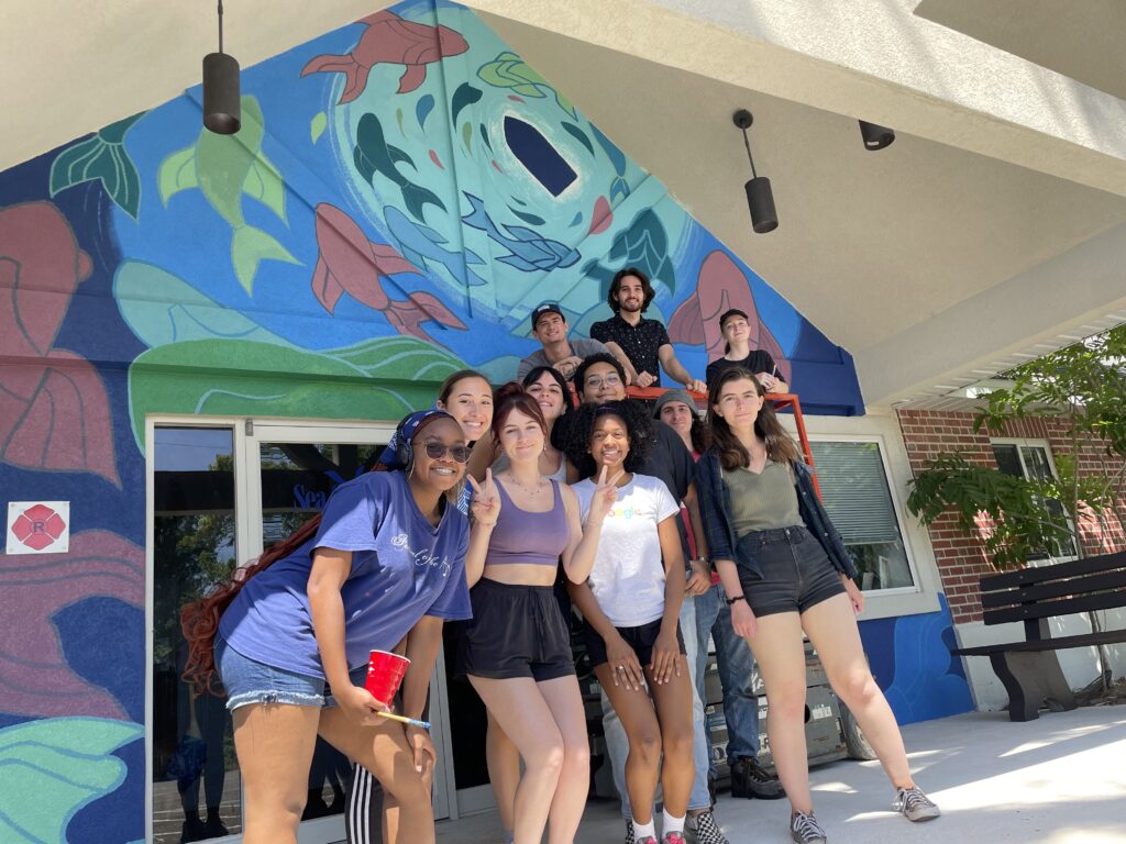 Students stand in front of the Florida Sea Grant mural. 
