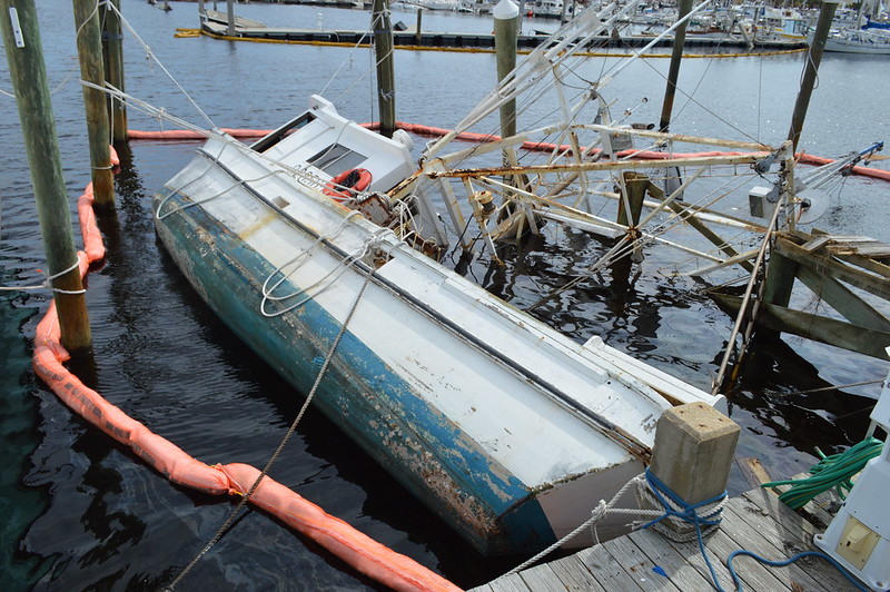 photo of boat turned over in water