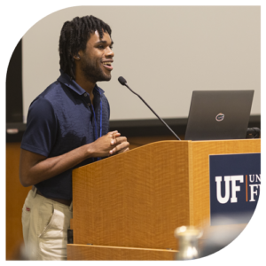 photo of student standing at podium presenting in classroom