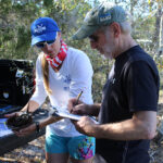 Dr. Savanna Barry and volunteer record horseshoe crab data.
