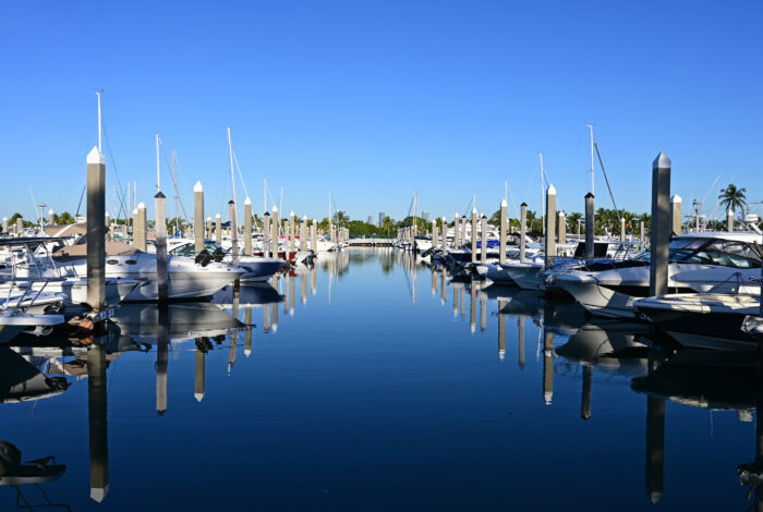 Boats docked in marina in Key Biscayne, Florida in early morning light on clear autumn day.