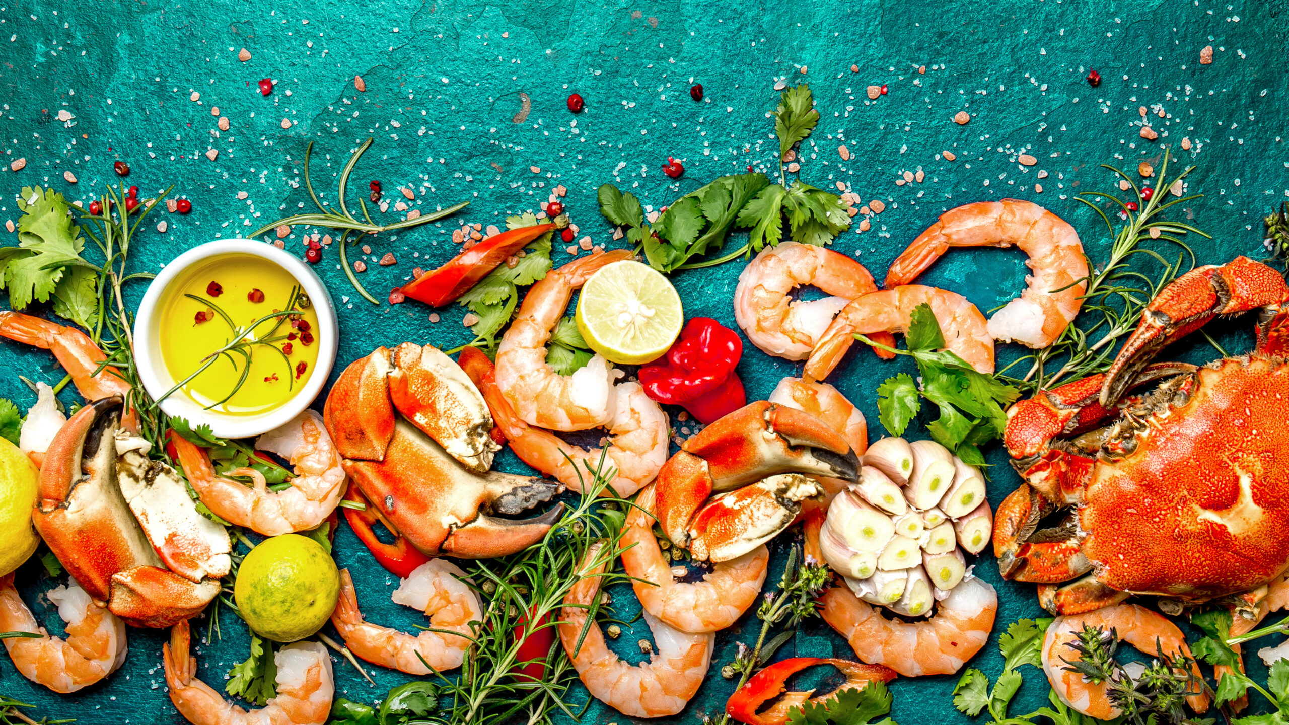 overhead photo of an arrangement of seafood and herbs