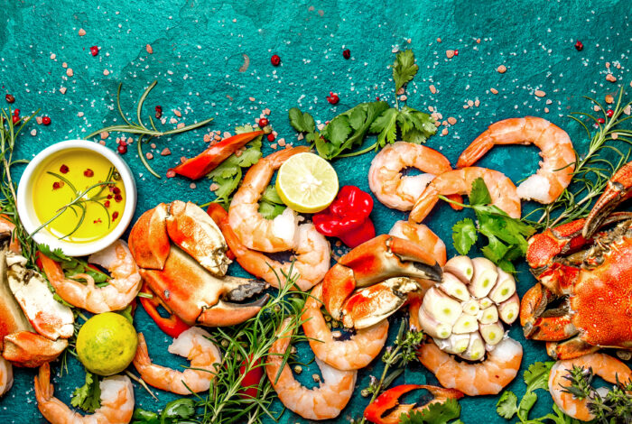 overhead photo of an arrangement of seafood and herbs