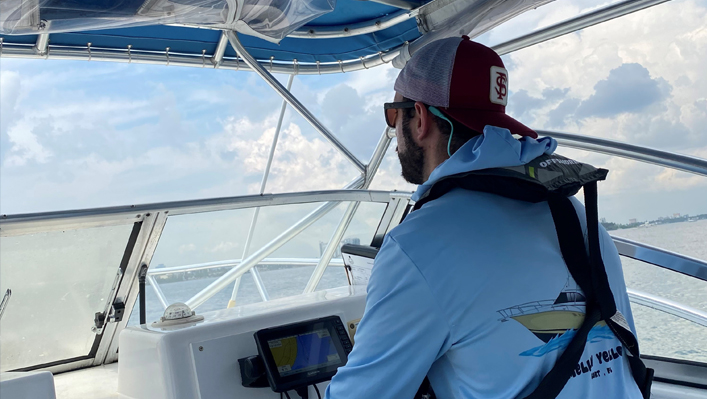 photo of chase osborn driving a boat
