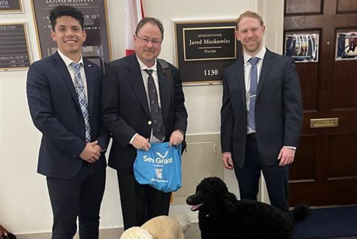 Roberto Ferrer, Dr. Charles Sidman, Representative Jared Moskowitz and two dogs