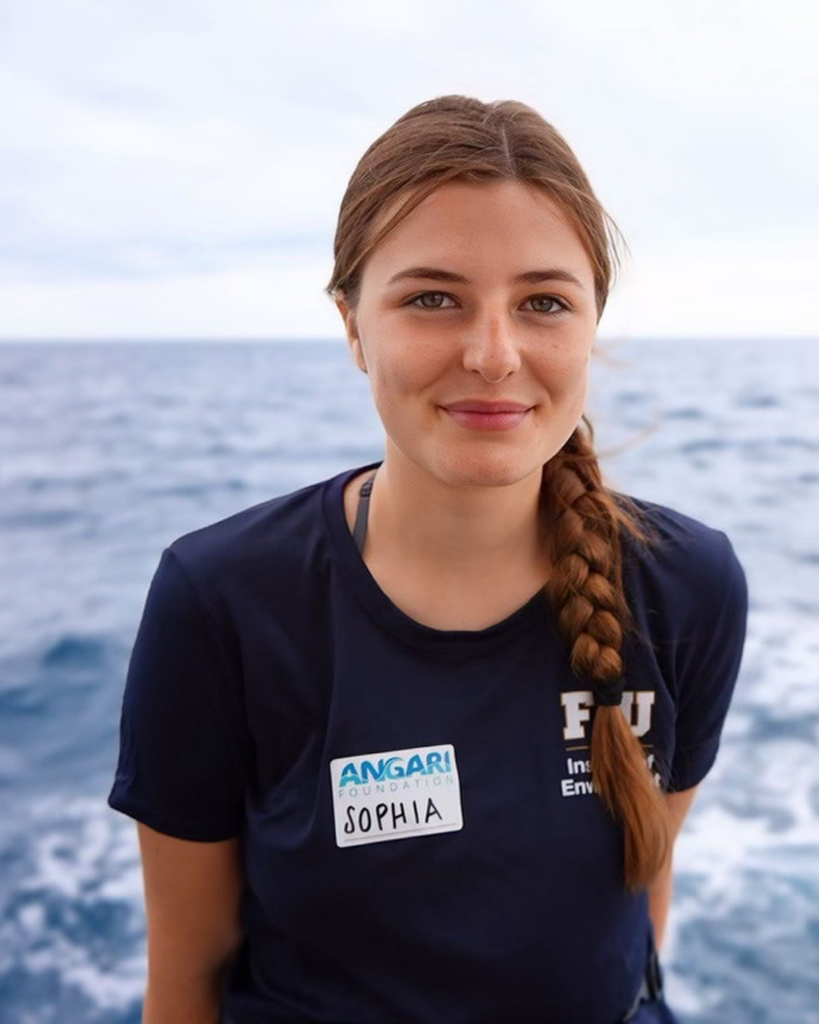 Headshot of Sophia Hemsi smiling with open water behind her.