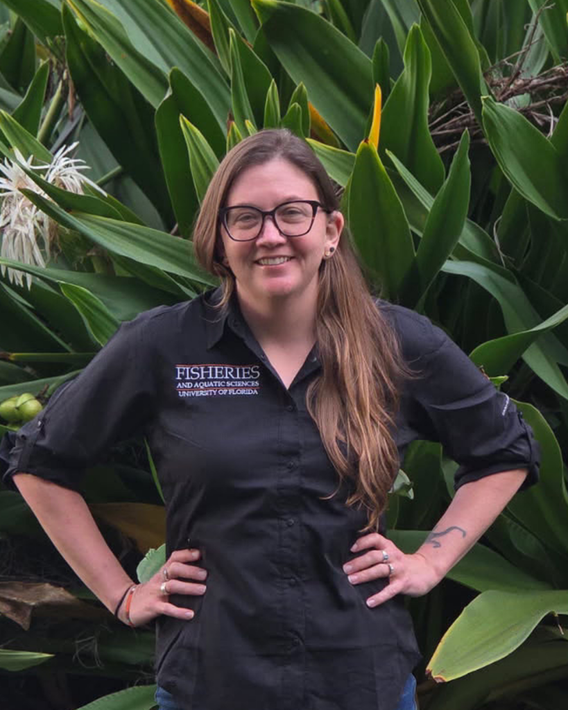 Headshot of Jessica Keller with plant foliage behind her.