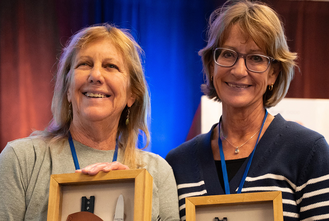 Leslie Sturmer and Dr. Sandra Brooke holding awards