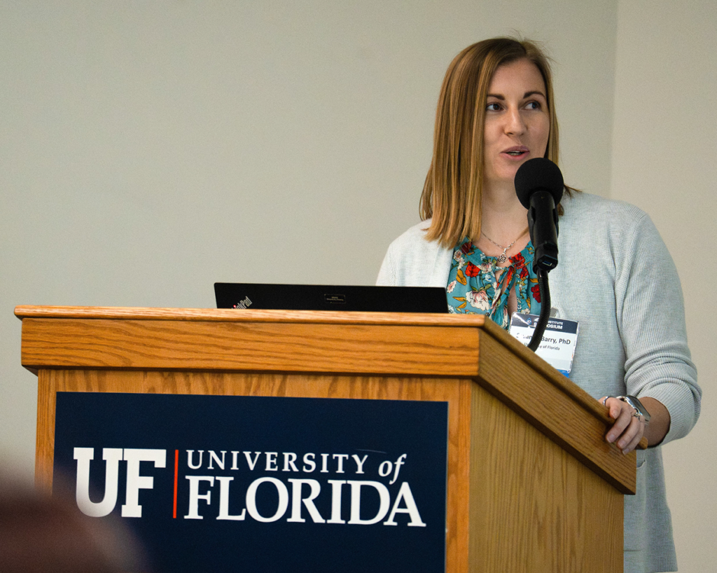 Savanna Barry stands behind podium while she moderates "Managing
and Restoring
Submerged Aquatic
Vegetation" session.