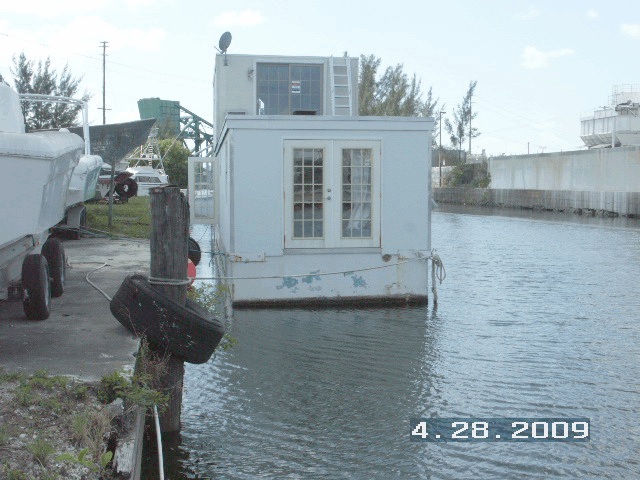That certain unnamed gray, two-story vessel approximately fifty-seven feet in length