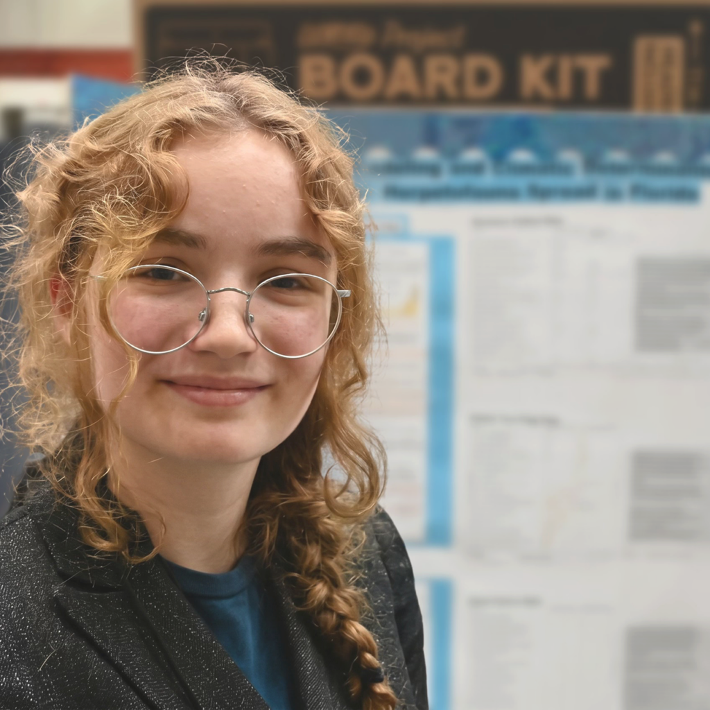 Elena Beck in front of science fair poster.