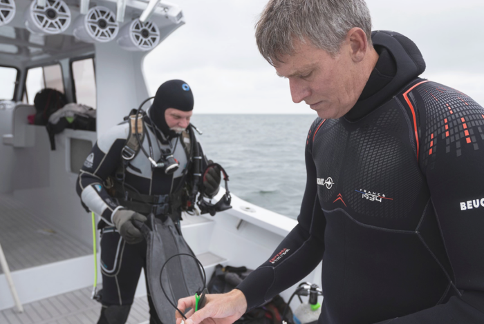Don Behringer on a boat preparing to conduct a research dive.