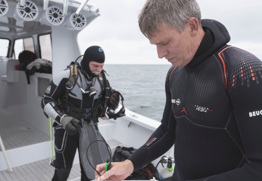 Don Behringer on a boat preparing to conduct a research dive.